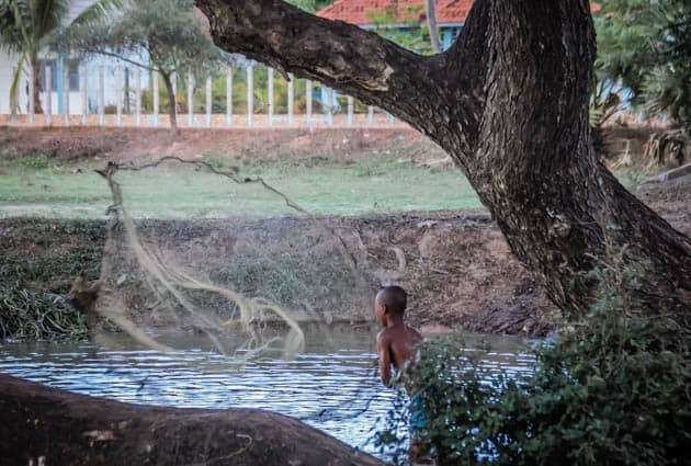 Local boy fishing Siem Reap Cambodia Photos