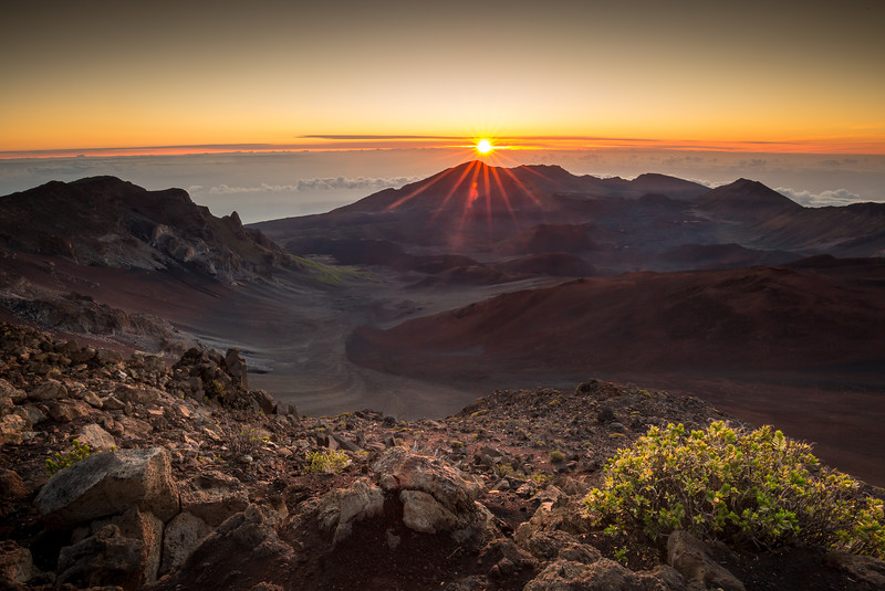 Starburst sunrise shot on the summit of Haleakala Volcano overlooking the volcanic crater in Haleakala National Park on Maui in Hawaii